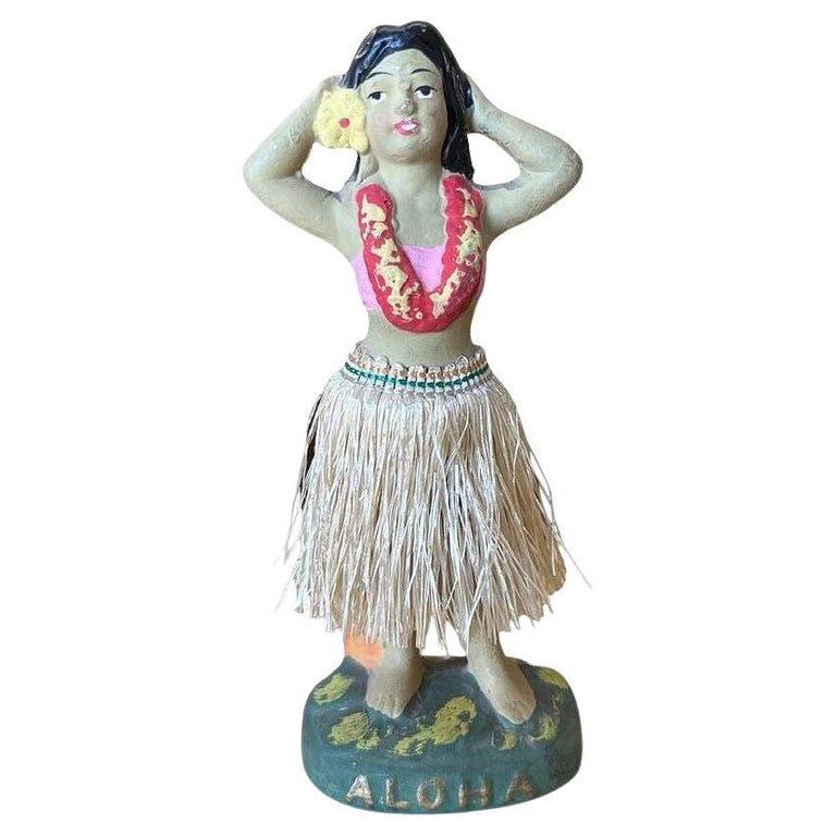 Post War Ceramic "Aloha" Hawaiian Dancing Hula Girl w/ Lei & Grass Skirt: Original post-war ceramic chalkware dancing Hawaiian Hula girl figurine made from lightweight plaster and painted in vibrant tropical colors and a fabric hula skirt. It depicts a young Hawaiian hula d