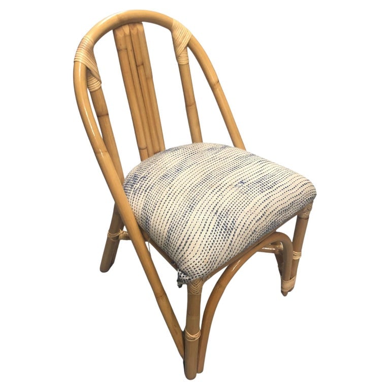 Restored Mid-Century Swoop Horseshoe Back Rattan Accent Chair: Restored Mid-century era rattan side accent chair featuring 5 strand seat back with a horseshoe arch that stretches from the front legs around the entirety of the chair to form a sculptural seat back.