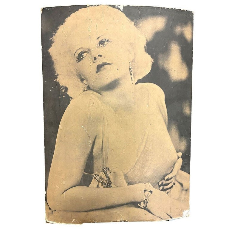 40" Tall Sepia Hollywood Starlett Photograph Jean Harlow Mounted to Pressboard: This glamorous 1950s matte poster-size photograph captures Hollywood icon Jean Harlow in an alluring yet tasteful pose. She gazes upward with a dreamy expression, her signature platinum blonde curls f