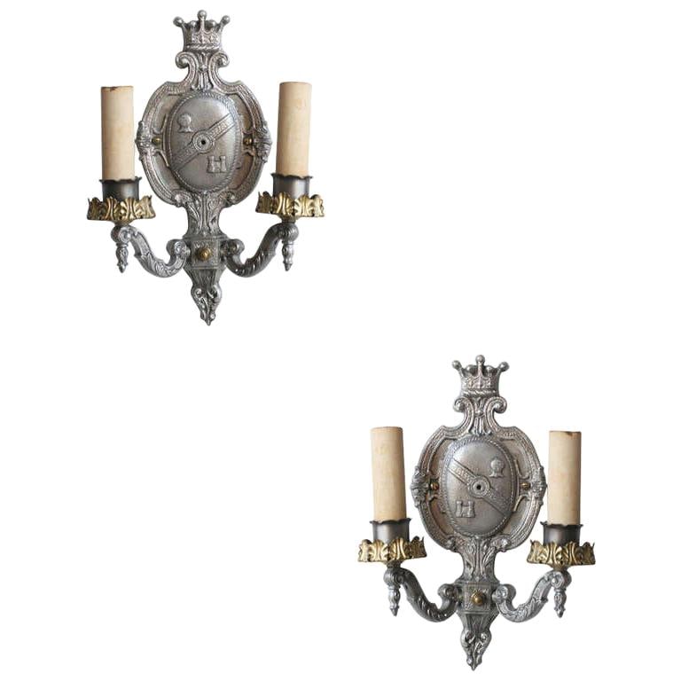Edwardian Aluminum Crest Wall Sconce: Edwardian aluminum wall sconce featuring a center crest with crown, armor head and castle.