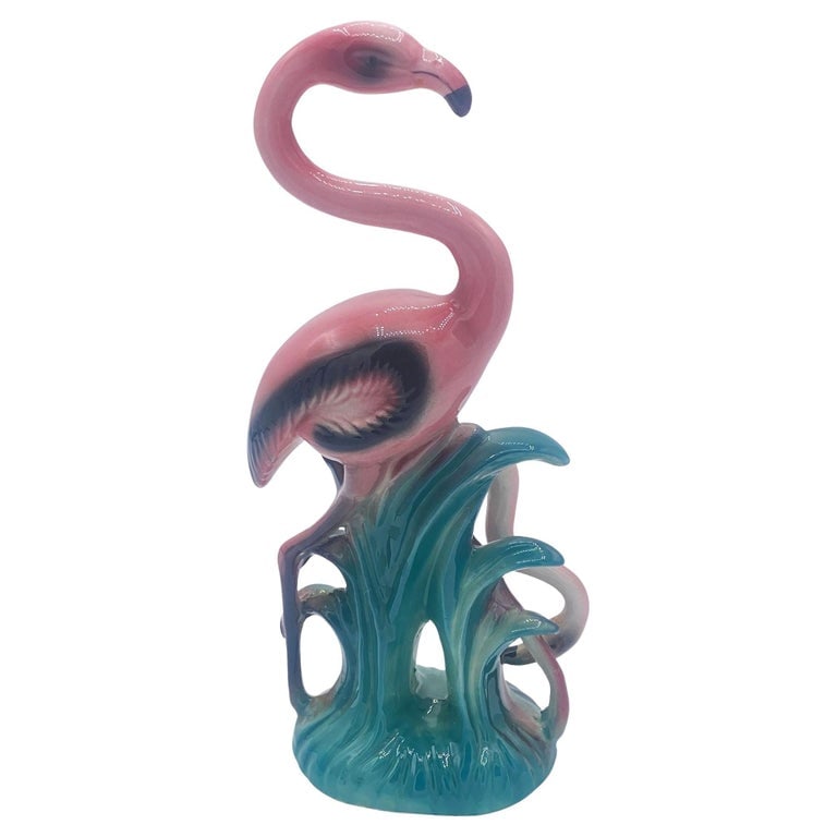 Mid-century Mother & Daughter Pink Flamingo Ceramic Tabletop Statue By Leftons: Mid-century pink and green ceramic flamingo tabletop pottery statue by Leftons. The statue features a beautifully detailed pink mother flamingo standing on a grassy field with daughter. It comes in a