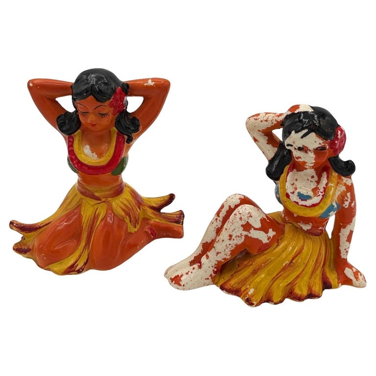 Mid-century Hawaiian Sitting Hula Girl Ceramic Figure Statue Set, Pair: Mid-century Era brown and yellow hula girl ceramic figure set. Each sculptural figure features a beautifully detailed pink hula girl sitting on the ground, posing during a performance. It comes in a