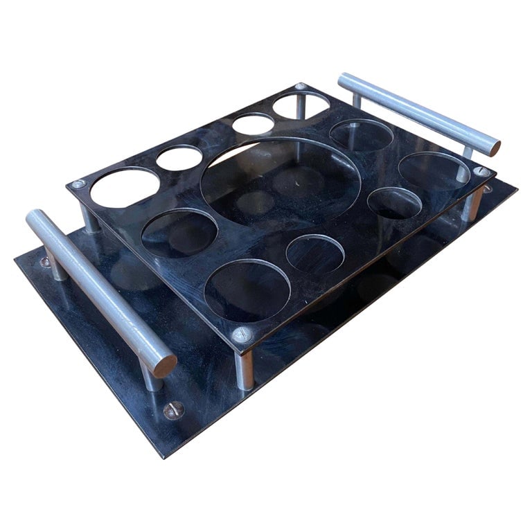 Aluminum and Bakelite Drink holder Tray by Aero-Art Los Angeles: The Aluminum and Bakelite Drink Holder Tray by Aero-Art Los Angeles blends vintage aesthetics with modern functionality. Crafted with durable aluminum and sleek Bakelite accents, it exudes elegance wh