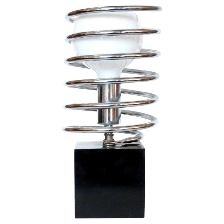 1960s Modernist Spring Table Lamp by Sonneman Lighting Company: This Modernist spring table lamp features a black steel cube with a chrome socket surrounded by a large chrome coil spring.It's unique and elegant simplicity is an exquisite example of a late 1960s de