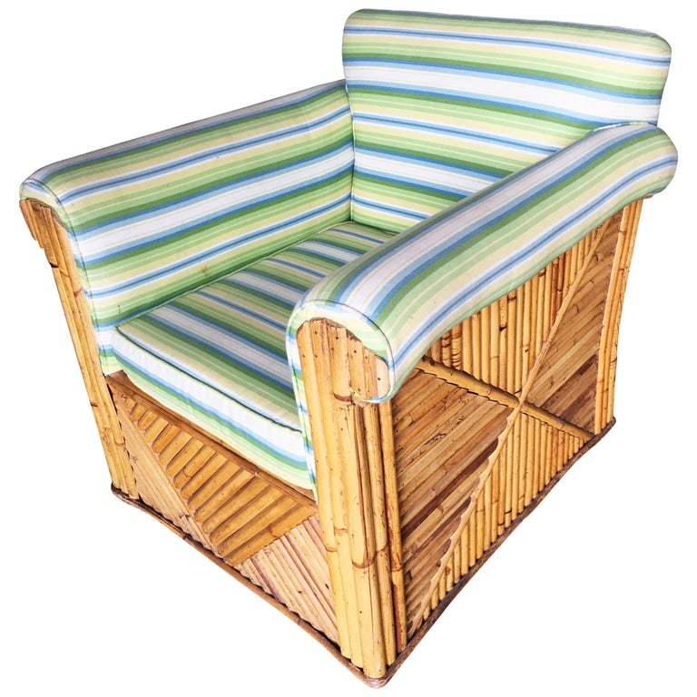 Rare Large Rattan "Big Daddy" club Lounge Chair: Large "Big Dady" club rattan lounge chair with green stripe fabric. This chair features a grouped pole leg design with X patterned sides and a large frame.Inspired by Paul Frankl this lounge is one of