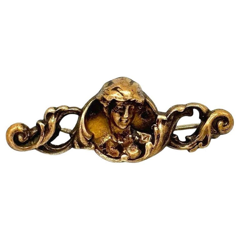 Art Nouveau Celestial Nymph Female Cameo Brass Brooch: Art Nouveau Brass pin and pendant showcase a female cameo of a celestial nymph. The intricate design features delicate detailing, capturing the beauty of its feminine silhouette with graceful precisio
