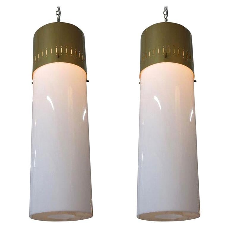 Midcentury Cylinder Pendant Pair in Gold, circa 1950: Pair of midcentury hanging lamps featuring a vented gold tone aluminum cap with a white acrylic cylinder shade. Price per pair - 2 pairs available.