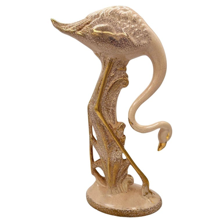 13" Tall Pottery Ceramic Beige Long-legged Flamingo Figurine, 1970: Rare 1970s Modernist light pink and gold long-legged flamingo ceramic figurine. The statue detailed a pink flamingo with long legs, a slim, tall form standing on a grassy field. It comes in a gloss fi