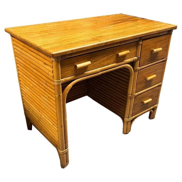 Restored Boutique Rattan & Mahogany Writing Desk w/ Stacked Rattan Sides: Experience the allure of tropical-inspired mid-century design with this Paul Frankl inspired restored rattan and mahogany writing desk. This desk features stacked rattan sides and mahogany drawer fron