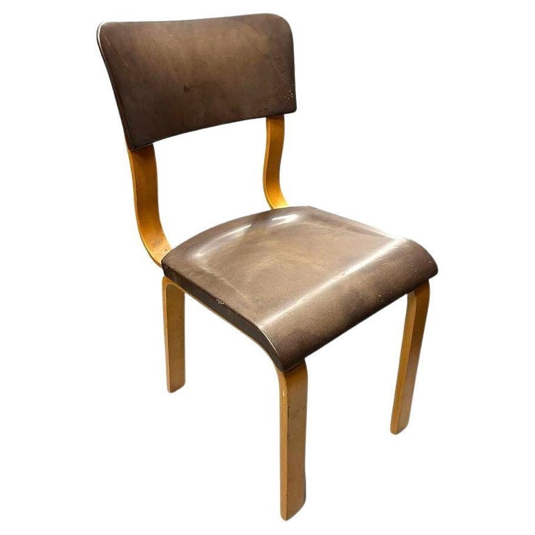 Art Deco Thonet Bentwood Dining Chair w/ Bakelite Seat: This original Thonet bentwood armchair features a Bakelite seat and backrest. The chair's bentwood beech frame is elegantly curved, showcasing the transition between Art Deco and the later Mid-century