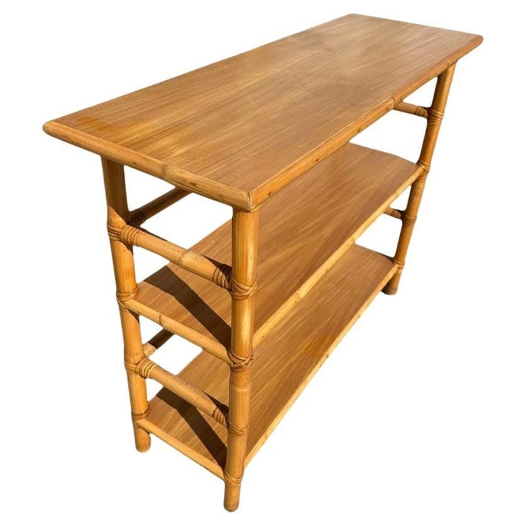 Restored Mid-Century Rattan and Mahogany Bookcase Console Table: Postwar Paul Frankl inspired a three-tier console table Bookshelf with mahogany tops and a wrapped stick rattan frame. The table has mahogany tops along each shelf, which are decorated with rattan tri