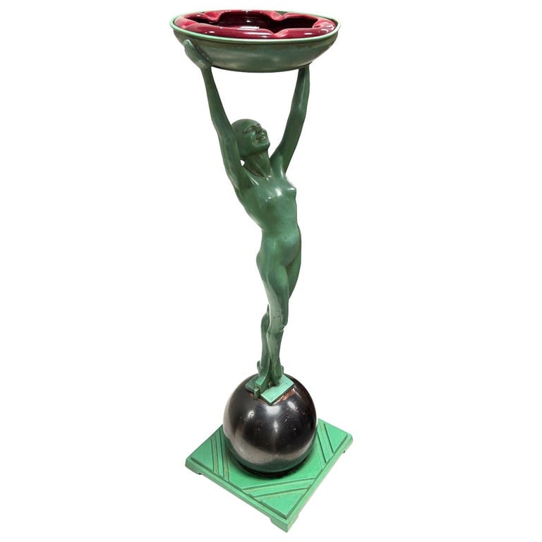 Frankart Standing Nude on Ball Art Deco Sculptural Smoke Stand Model T330: Classic Model T330 Nude Art Deco Flapper girl Ashtray stand by the Frankart Metworks company, a classic piece of luxury artwork from the 1920s. The stand features a green metal woman holding up an ash