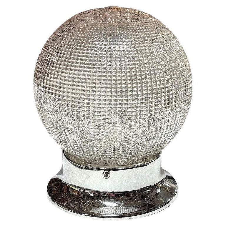 Mid-century Holophane Glass Globe Pendant Light w/ Chromes Steel Fitter: Hollywood Regency style Holophane ceiling pendant features a classic globe-shaped glass shade that beautifully diffuses light into a sparkle. A chromed steel fitter complements the textured glass, add