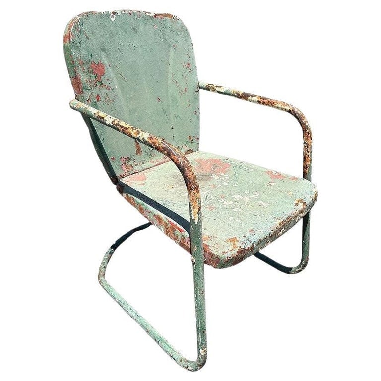 Mid-century Steel Shellback Springer Patio Outdoor Lounge Chair: Steel Mid-century Springer Outdoor green enamel Lounge Chair. The chair features a round tubular U-shaped base that rocks and forth when pushed back and forth. The chair features a Shellback pressed s