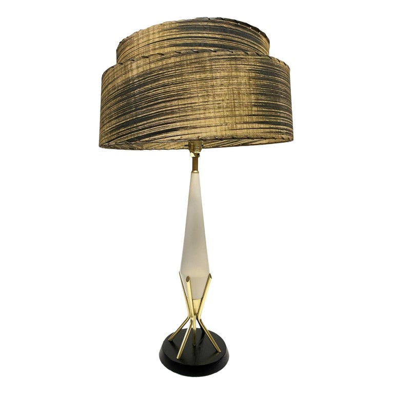 Mid Century Googie Table Lamp W/ Spun Fiberglass Shade: Original Mid Century Googie table lamp featuring a black base connected to 3 brass rods which support tapered lamp neck.Included is the whipple stitch fiberglass lamp with modernist pattern along the 