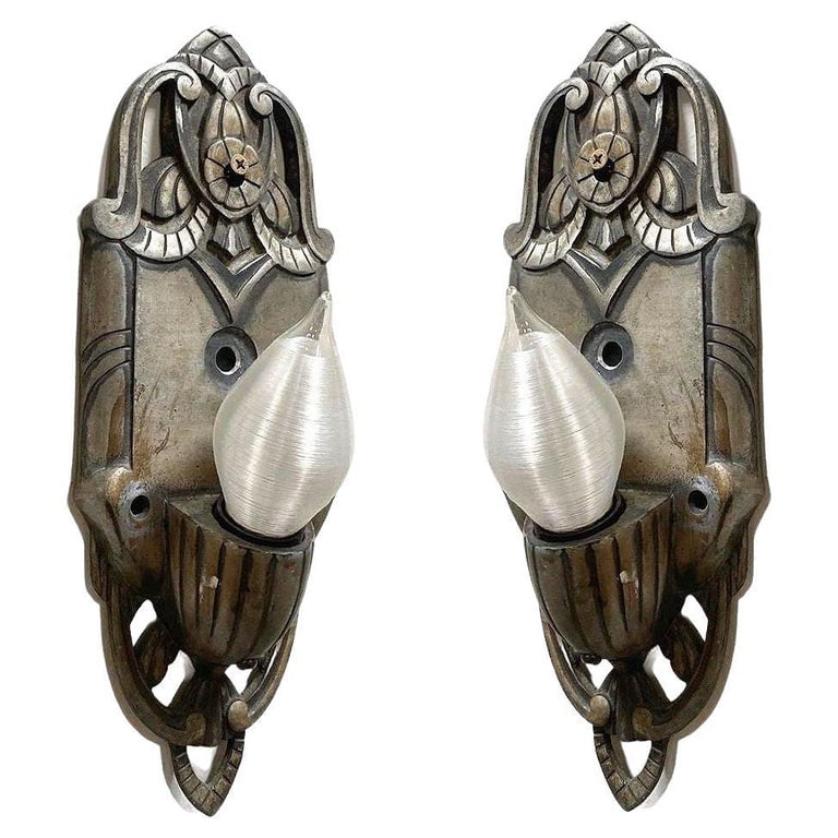 Early Art Decco Machined Aluminum Wall Sconce, Pair: Pair of early art deco machined aluminum wall sconces with graceful curves and geometric lines with a floral motifs in the center of the back plate, giving an elegant yet modern design.Dimensions: Hei