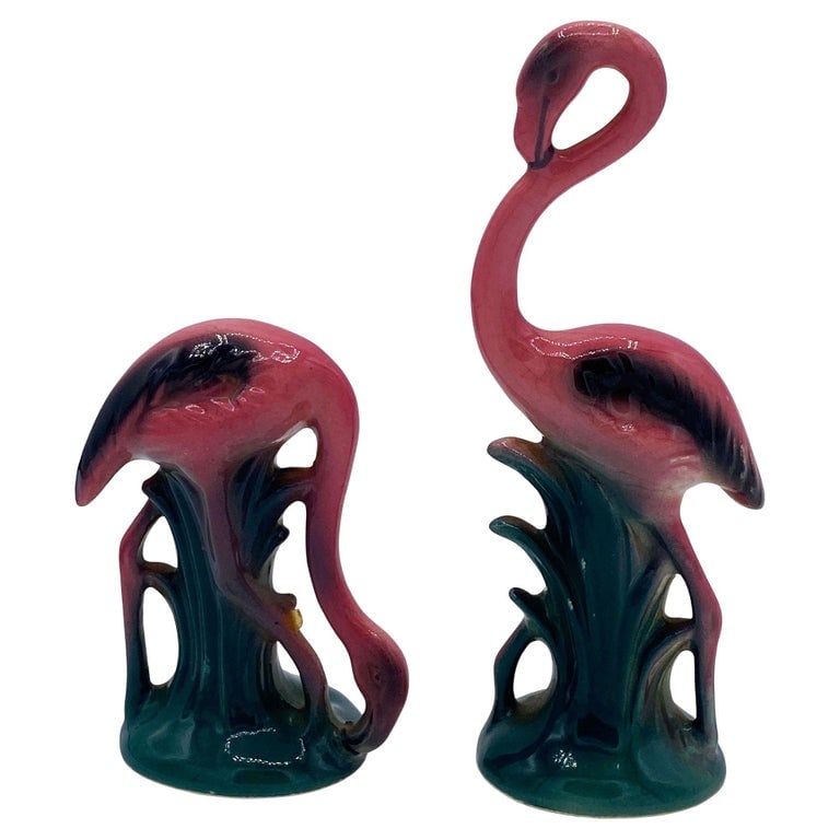 MCM Ceramic Miniature Pink Flamingo Tabletop Statue His & Hers Set By Leftons: Mid-century pink and green ceramic flamingo statue set by Leftons. The set features two beautifully detailed pink flamingos in lush green leaves and grass with a pink color. Each comes with a gloss