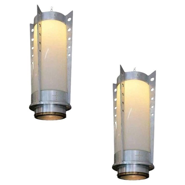 Mid-Century Aluminum Cylinder Pendant circa 1960, Pair: This Mid-Century pendant light pair was manufactured during the Jet Age era of the Space Race and America's obsession with speedy flight and reaching to the stars.It showcases all the Hallmarks of its