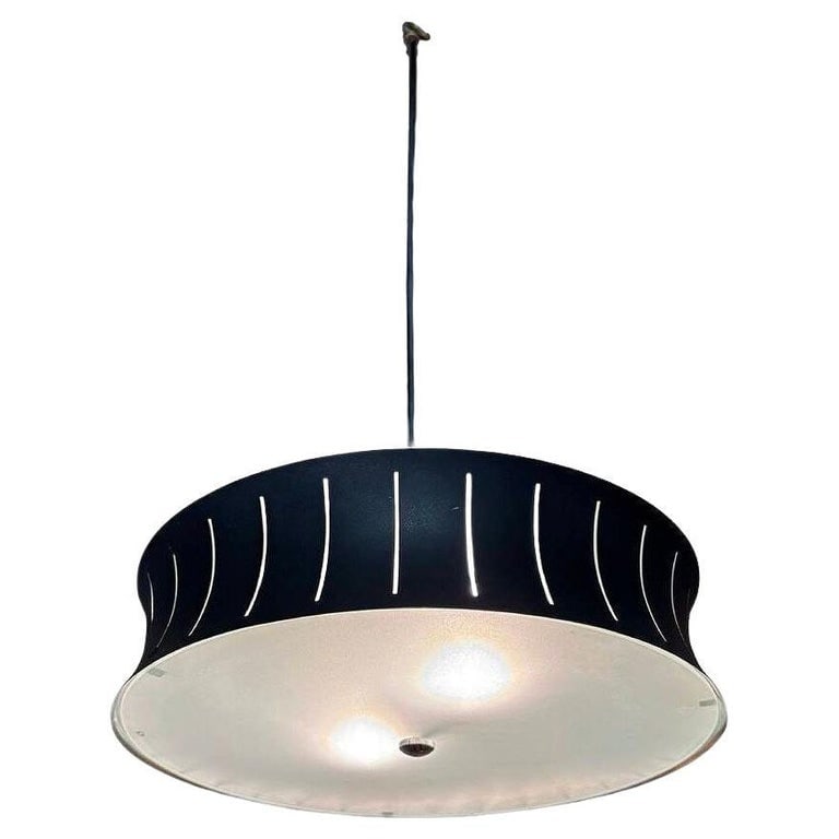 Restored Mid-Century Googie Drum Pendent Black and White Chandelier Lighting: Mid-century Googie styled black drum pendant light with an interior white diffuser and a metal shade featuring vertical cutouts. The clean lines, mixed materials, and distinctive cutouts are character