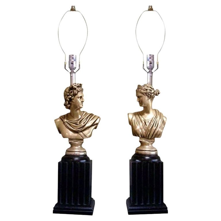 MCM High Style Hollywood Regency God & Goddess Pillar Table Lamps, Pair: This pair of 1950s Neoclassical-style table lamps features the busts of Greek gods mounted on the lower half of a lacquered Doric column. The figures are skillfully carved in wood and finished with a 