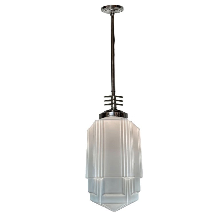 Art Deco Chrome Streamline Pendant Light w/ Skyscraper Milk Glass Shade: 1930s Art Deco pendant light featuring a stepped and line-textured "Skyscraper" milk glass shade and Streamline Art Deco light fixture . The pendant lamp showcases chromed finish body with 3 black ena