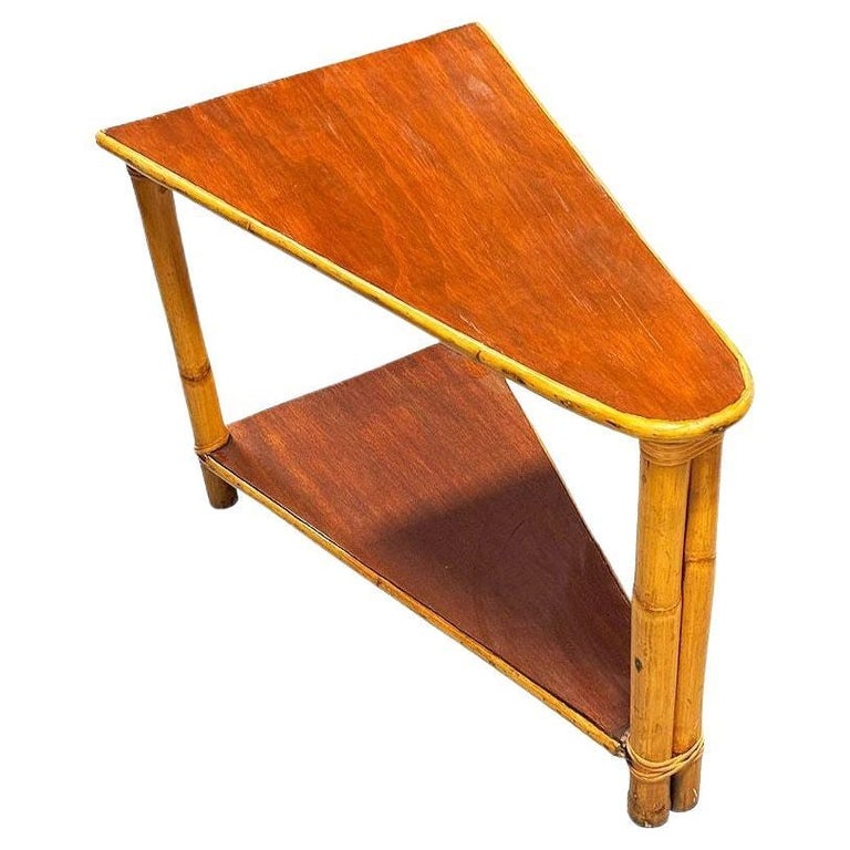 Restored Mid-century Rattan & Mahogany 2-Strand Wedge Side Table w/ Bottom Shelf: This beautifully restored rattan wedge table blends style and vintage charm with modern comfort. Made in 1950, it features a set of 2 mahogany tops standing on a single-strand rattan frame with a two-