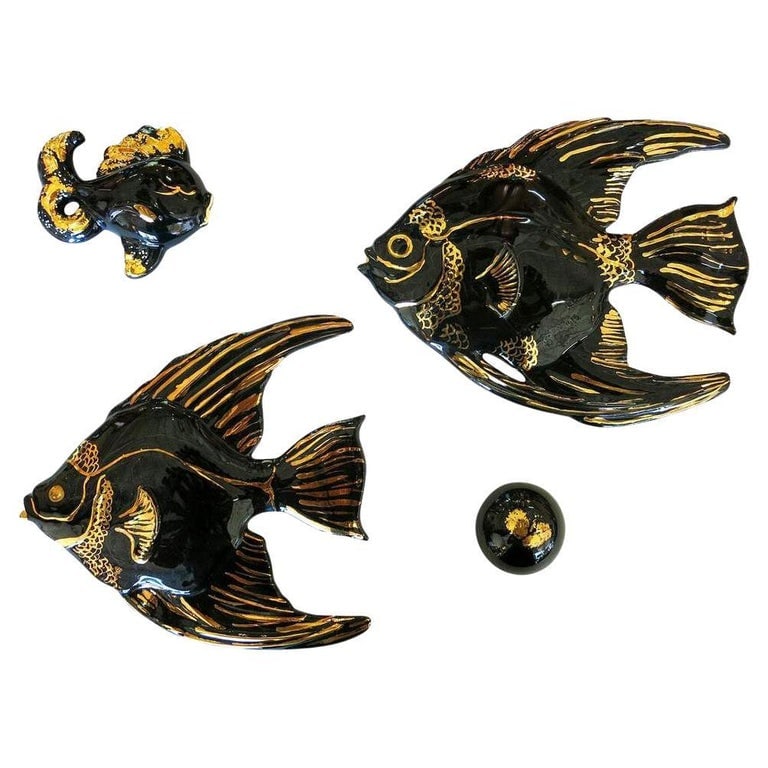 Mid-century Ceramic Black & Gold Plaster Aquatic Angelfish Wall Art, Set of 4: A unique Mid-century aquatic angelfish plaster wall art set featuring two adult angelfish, a young angelfish, and an extra decorative piece for 4 pieces in total. The set is finished in a high gloss B
