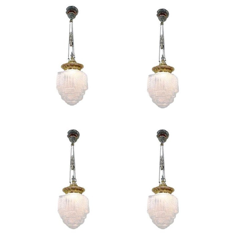 Art Deco Brass Ceiling Pendant w/ Stepped Blue Glass Deco Globe, Set of 4: Set of 4 1930s Art Deco pendant lights featuring a stepped and line-textured "Skyscraper" icy blue cobalt glass shade and ornate cast brass fitter with a warm copper finish. A striking architectural f