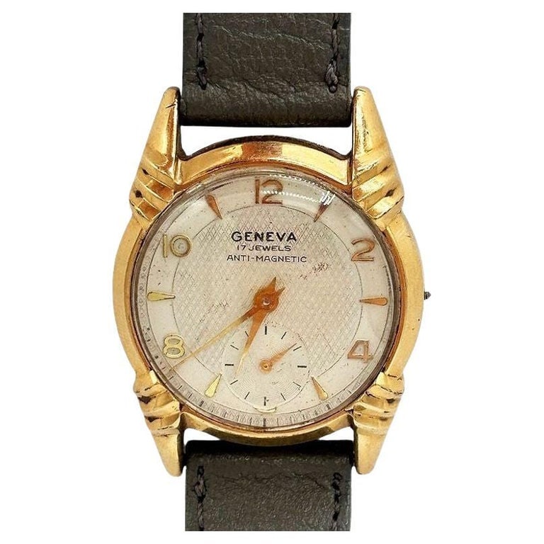 1970s 10k Geneva Sunburst Automatic Swiss Watch w/ Calfskin Band: This Swiss Made Geneva men's watch from circa 1970 is a timeless piece that exudes understated sophistication. The large 36mm dial features a captivating yellow sunburst design that catches the light 