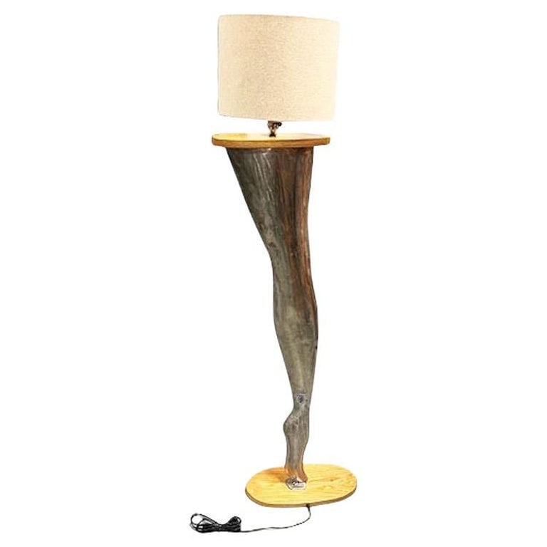 Postmodern Brushed Steel Female Leg Marilyn Monroe Floor Lamp w/ Shade 1990: Hand machined Brushed Steel Female Leg Floor Lamp inspired by Marilyn Monroe. This unique piece was forged and finished from raw steel to the shape of a human leg, with a carved pine wood cap and base