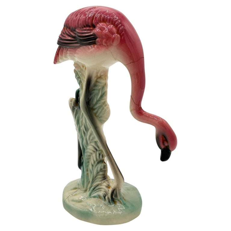 Mid-century California Pottery Ceramic Searching Pink Flamingo Figurine: Mid-century pink and green Drinking flamingo ceramic figurine. The statue detailed a pink flamingo with long legs, a slim, tall form standing on a grassy field, bowing down to take a drink. It comes