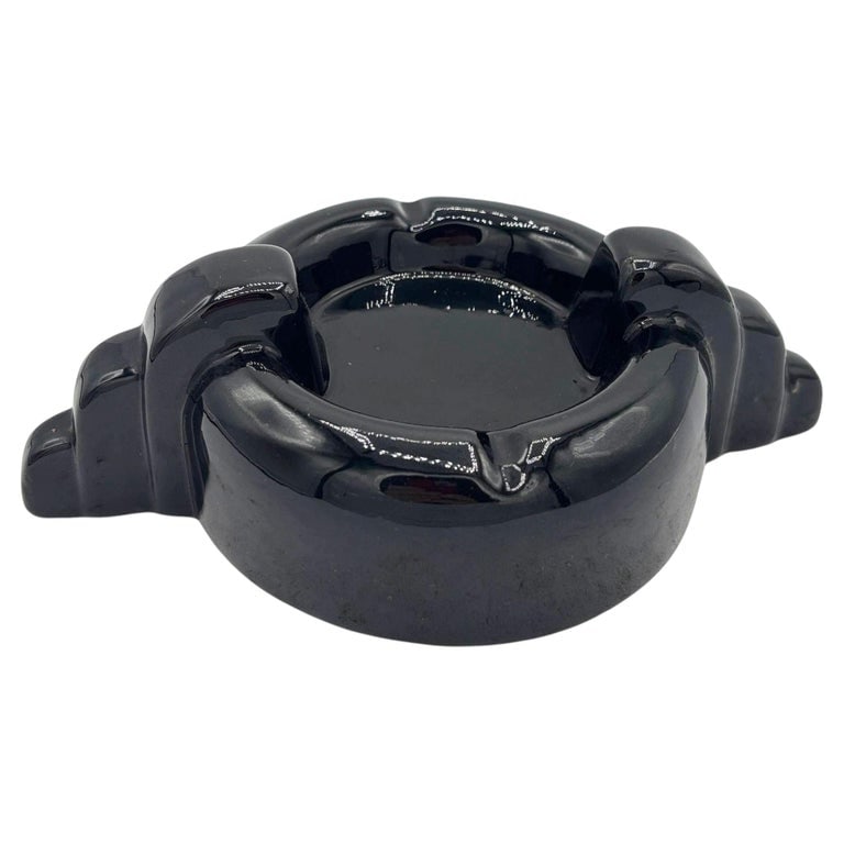 Rare Black Stepped Streamline Art Deco Ceramic Ashtray: Mid-century Pink and grey clamshell-shaped ceramic ashtray. The ashtray features an abstract, calm shell shape with a pink gloss finish interior and grey exterior.Stamped: "USA"Measurements: 3" Tall X