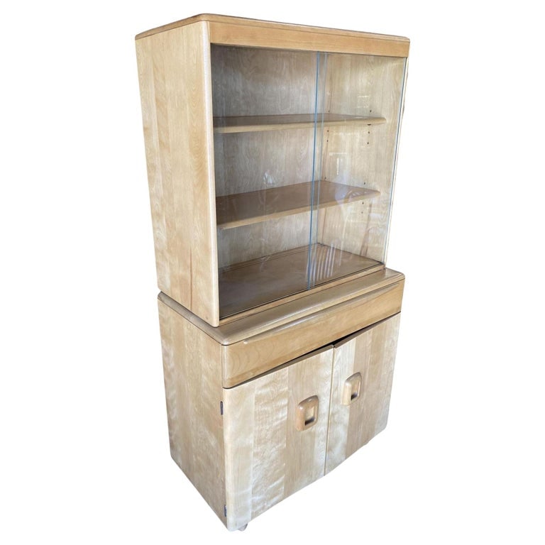 Blond "Encore" Step Back Cupboard China Cabinet Etagere by Heywood Wakefield: Mid-Century Modern era "Encore" china cabinet/step-back cupboard by Heywood Wakefield featuring a light blond finish birch. The cabinet has an upper showcase with two sliding glass doors that open to 