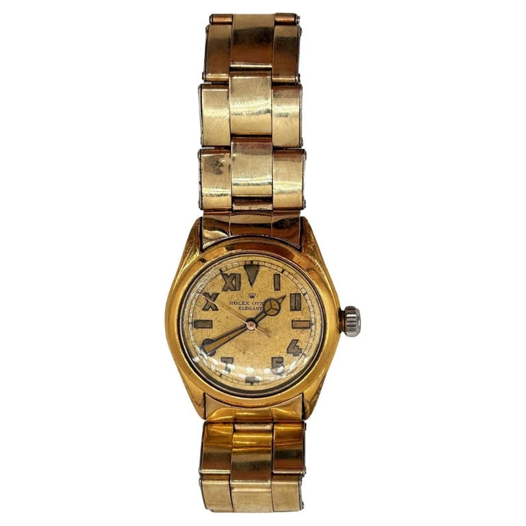 1947 Rolex Oyster Bubbleback “Elegante?? Gold-Plated Wristwatch w California Dial: This vintage 32mm Rolex Oyster “Elegante” wristwatch showcases timeless sophistication with its classic gold-plated case and matching oyster rivet bracelet. Also known as a "Bubbleback" for it