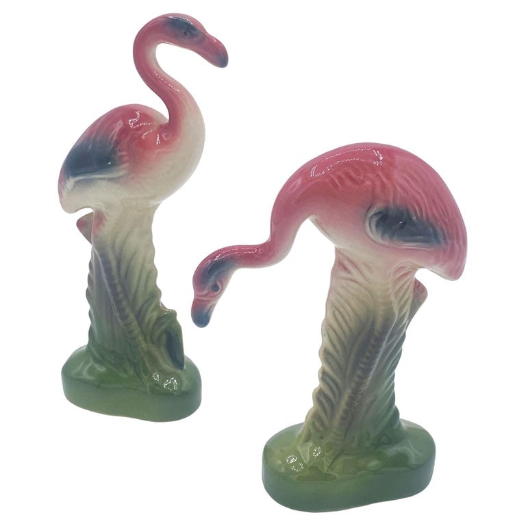 Mid-century Matching Miniature Pink Flamingo Ceramic Tabletop Figure Statues: Mid-century pink and green miniature ceramic flamingo tabletop California pottery vase set of matching His and Her set . The set features two beautifully detailed pink flamingos in lush green leaves a