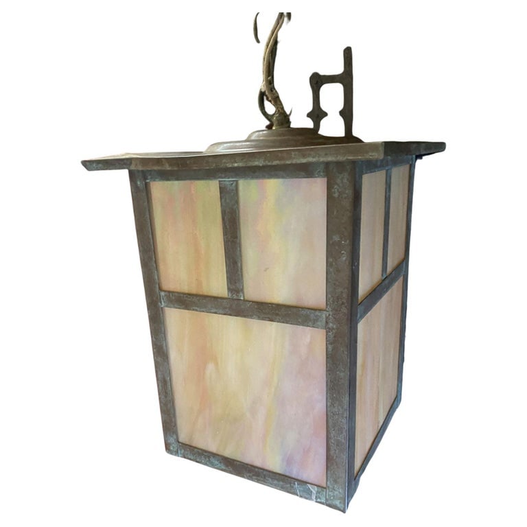 Arts and Crafts Bronze Sconce on Chain w/ Iridescent Art Glass Shade: Arts and crafts bronze pendant light sconce on chain w/ iridescent art glass shade featuring bronze lantern hanging from bronze wall fixture. Circa 1910