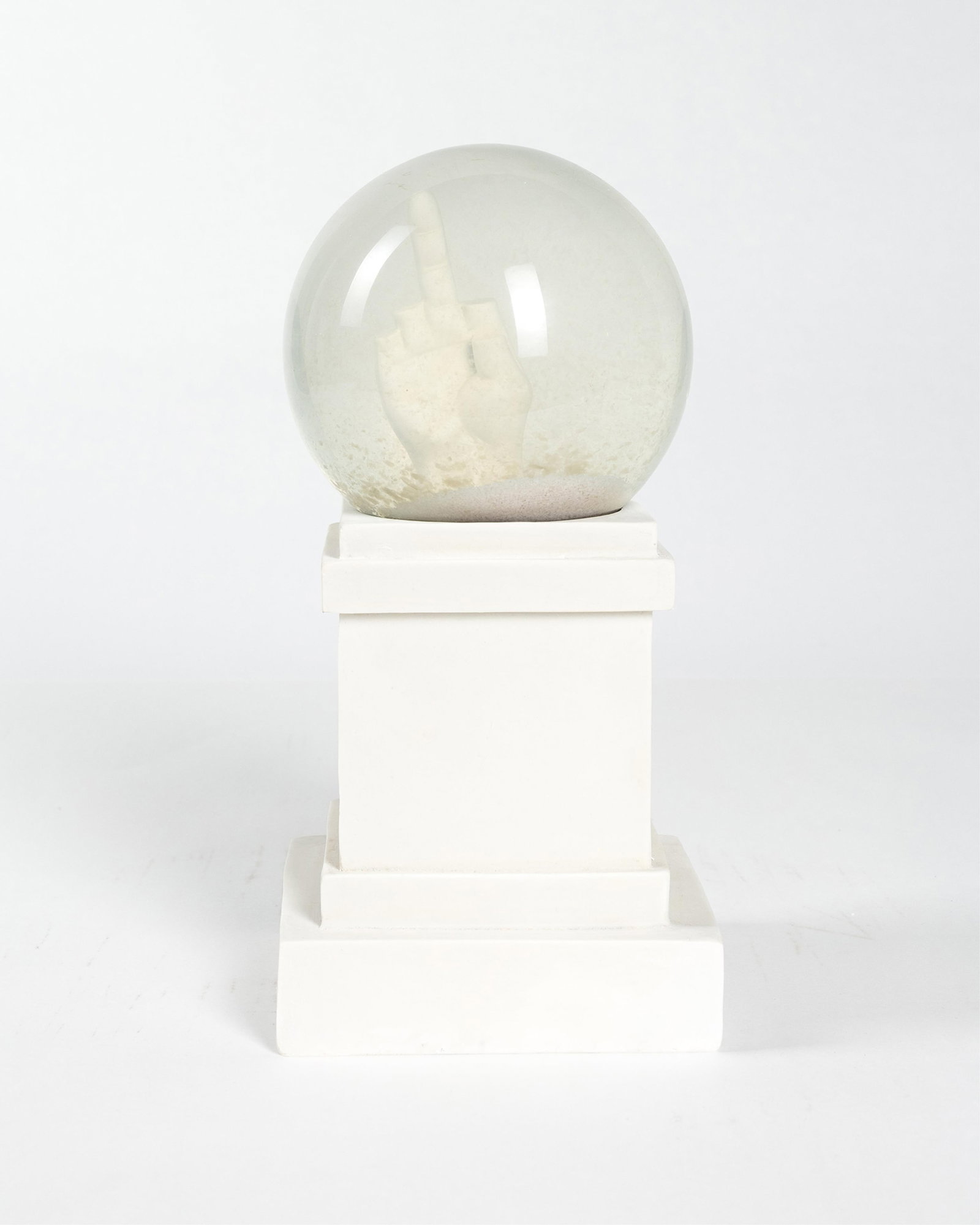 Maurizo Cattelan, b. 1960, L.O.V.E.: Maurizo Cattelan b. 1960 L.O.V.E. 2010 snowball (snow globe) resin, glass, water, and glitter 1:47 replica of L.O.V.E. located in Milan, Italy 9 inches (height) 11-1/2 x 6-3/4 x 6-3/4 (box)
