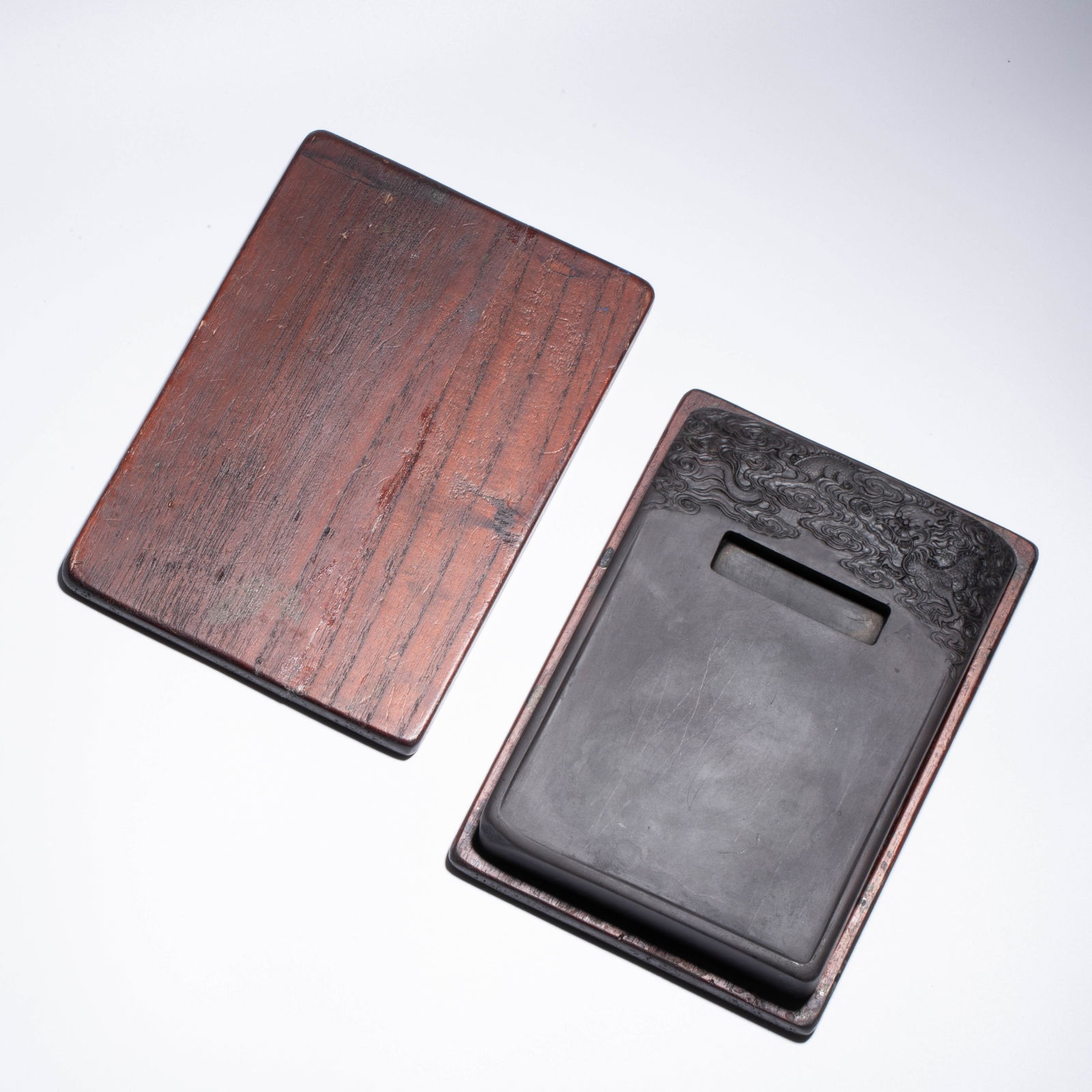 Cloud and Dragon Inkstone from Duanxi Laokeng Shuiyan, Qing Dynasty: Cloud and Dragon Inkstone from Duanxi Laokeng Shuiyan, Qing Dynasty Square inkstone carved from Duanxi Laokeng Shuiyan, with high-relief cloud and dragon motif, retaining natural stone skin, Qing Dyna