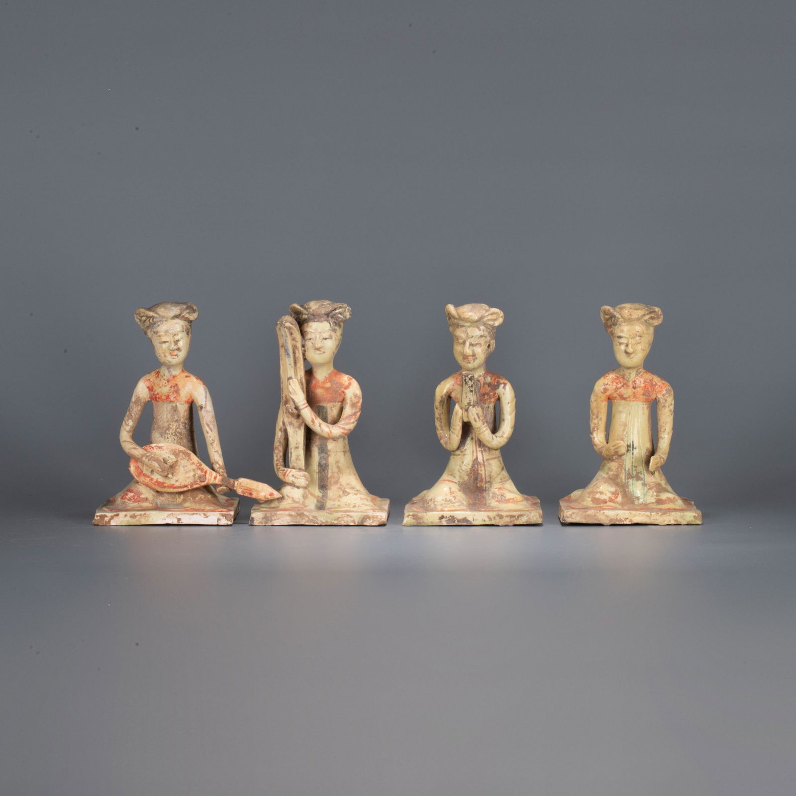 A set of Sui Dynasty celadon-painted figurines of female entertainers: A set of Sui Dynasty celadon-painted figurines of female entertainers