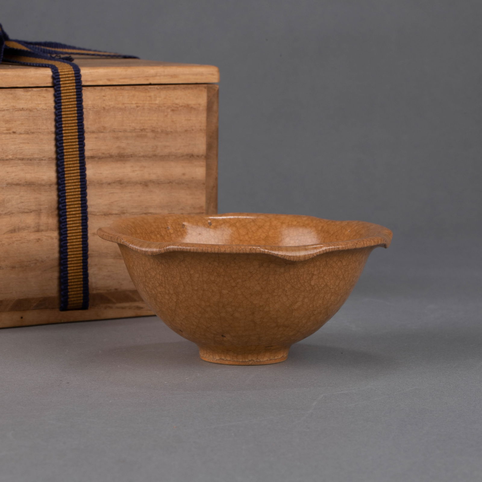 Southern Song Dynasty Longquan Kiln ‘Turtle-Leaf’ cup: Southern Song Dynasty Longquan Kiln “turtle-leaf” cup – Lotus-leaf rim with turtle-shell vein patterns; pale bluish-brown glaze with dense cicada-wing crackle; glaze pooling like morning dew