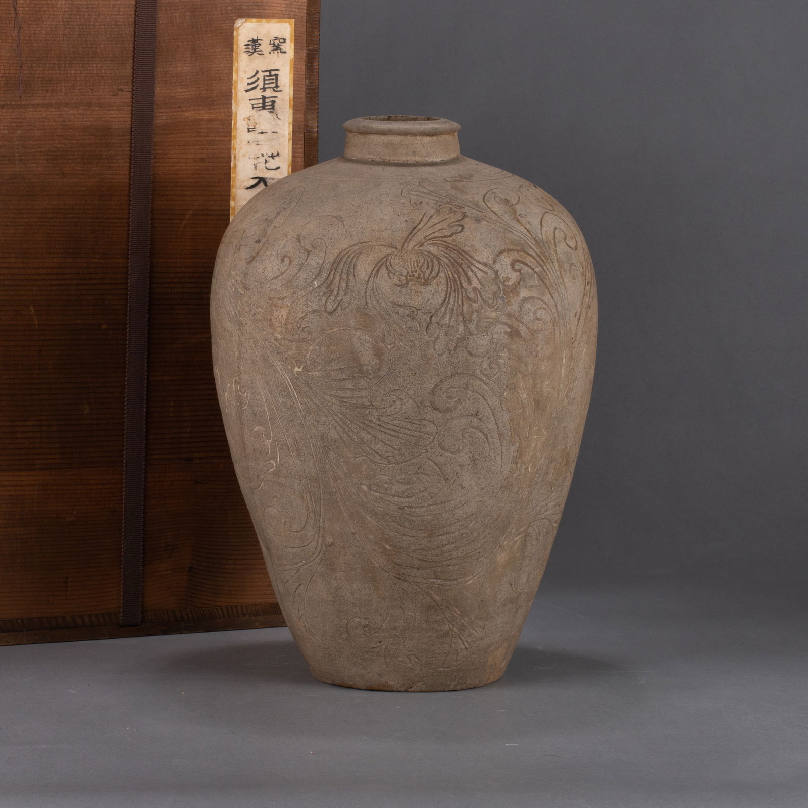 Song Dynasty Sue Ware Flower Vase: This Song Dynasty Sue ware flower vase features a plum-vase form with a gently contracted mouth and full shoulders. Its body is incised with sparse, fluid floral motifs that harmonize with the unglaze
