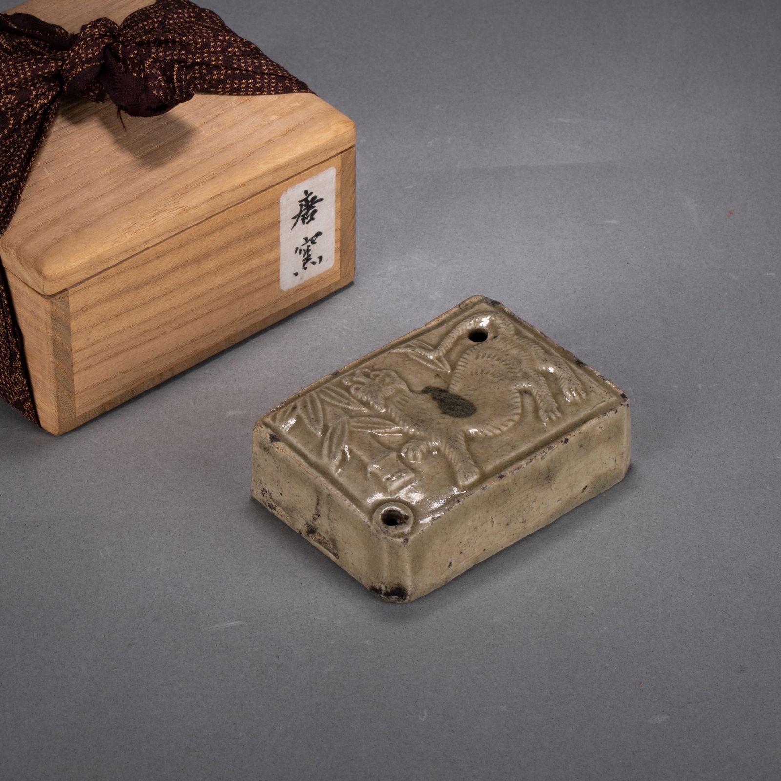 Ming Dynasty Zhangzhou Kiln Lion-design Water Dropper: Ming Dynasty Zhangzhou Kiln Lion-design Water - This water dropper takes a rectangular slab form and is covered overall in a warm bluish-gray glaze. On the front, a fierce lion is sculpted in relief��