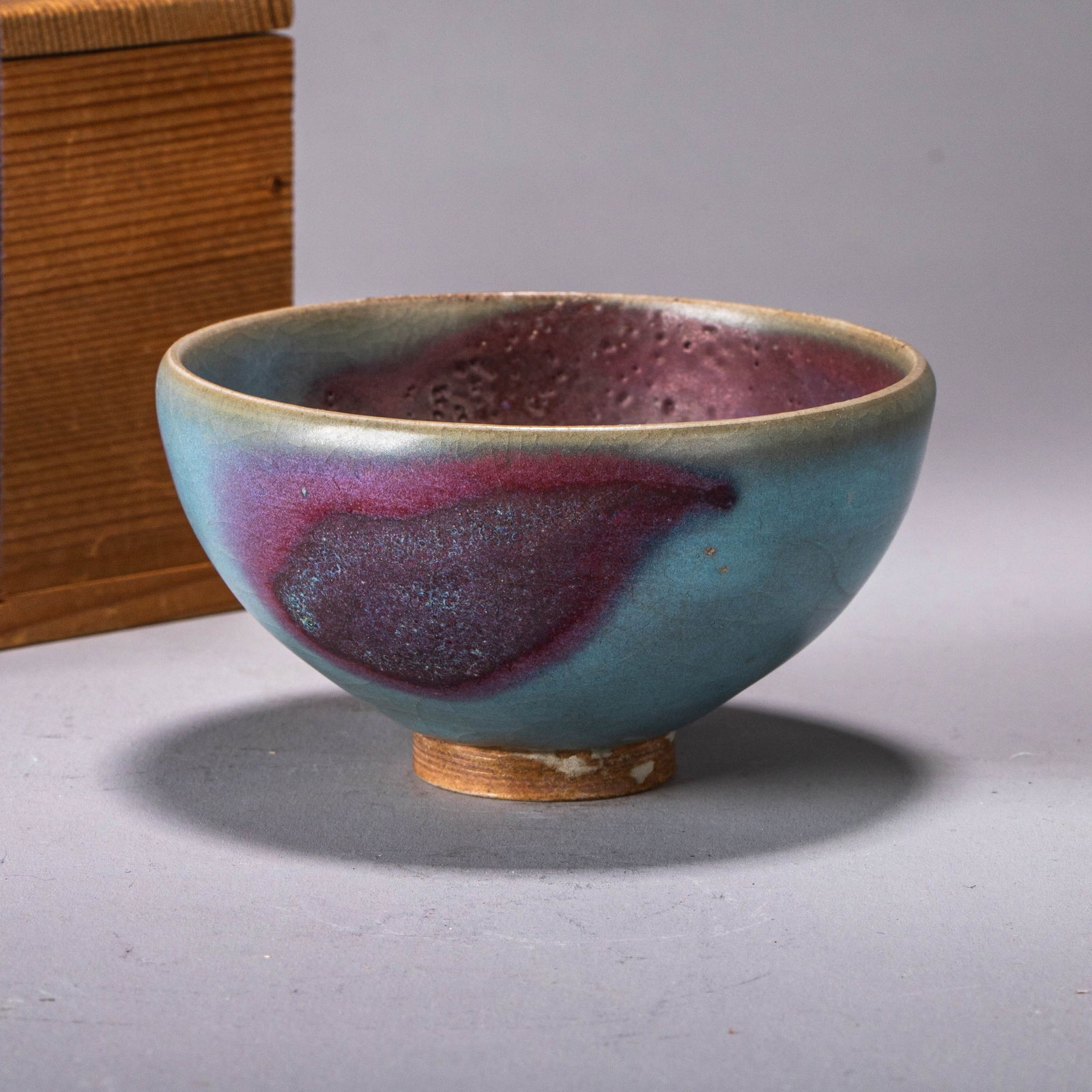 Jun ware small cup with purple splashes: Jun ware small cup with purple splashes - This small cup features a delicate, rounded form that fits perfectly in the hand. Both the interior and exterior are fully covered in an opaque sky-blue glaze