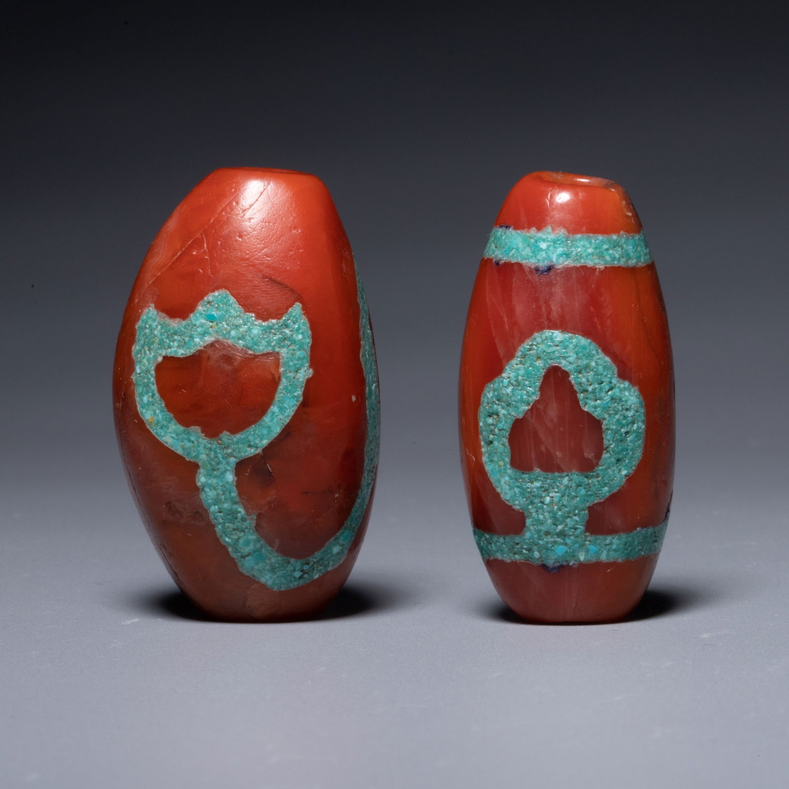 A pair of Ming Dynasty southern red agate lotus-patterned lezi beads: A pair of Ming Dynasty southern red agate lotus-patterned lezi beads