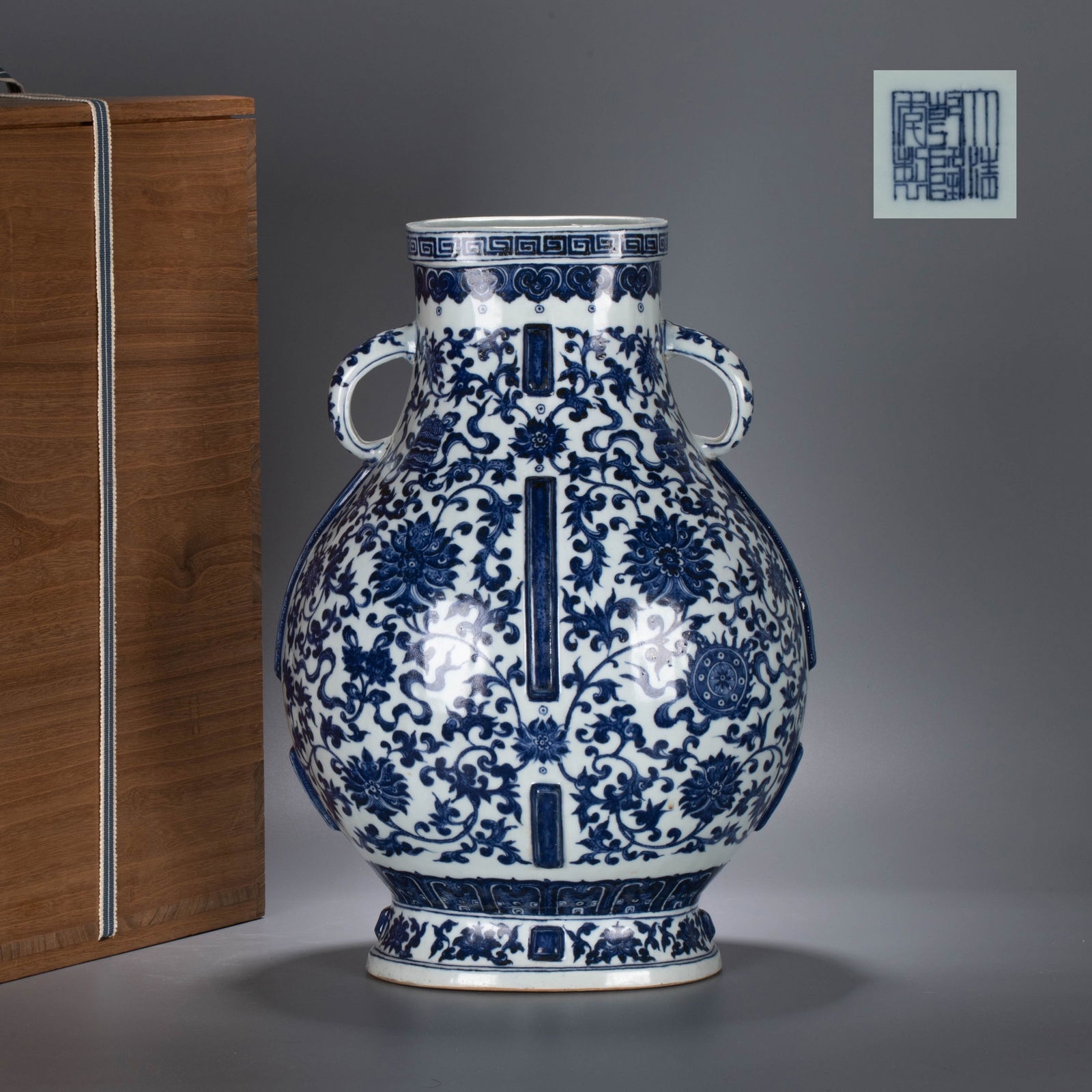 Qianlong Era Blue-and-White Floral Pattern Vase with Handles: Qianlong Era Blue-and-White Floral Pattern Vase with Handles - This blue-and-white zunvessel is dignified and full-bodied in form, featuring a flared rim and a neck adorned with a fretwork pattern. A