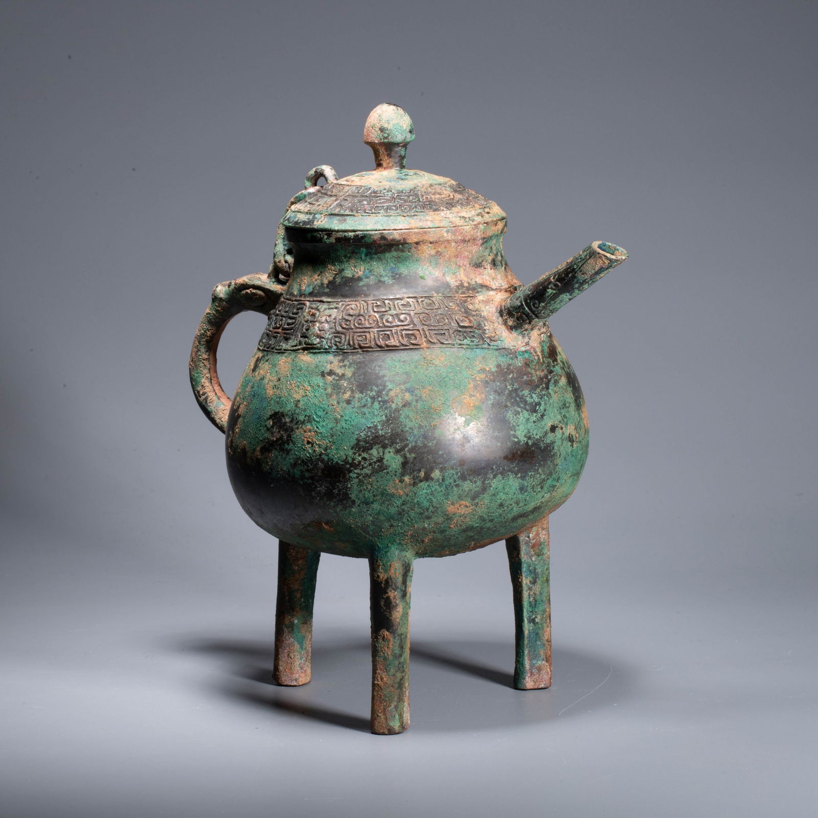 Shang Dynasty Bronze Gai (Cover): Shang Dynasty Bronze Gai (Cover) - This Shang Dynasty bronze he(a ceremonial wine vessel) has a robust and archaic form, with a tall, rounded knob on the lid, which is adorned with cloud-and-thunder p