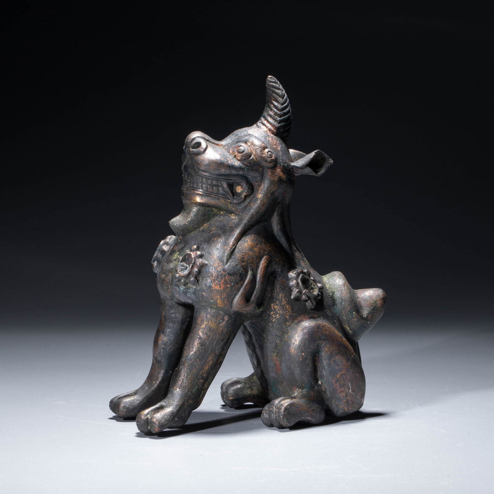 A gilt-bronze figure of a mythical beast, Ming dynasty: A gilt-bronze figure of a mythical beast, Ming dynasty