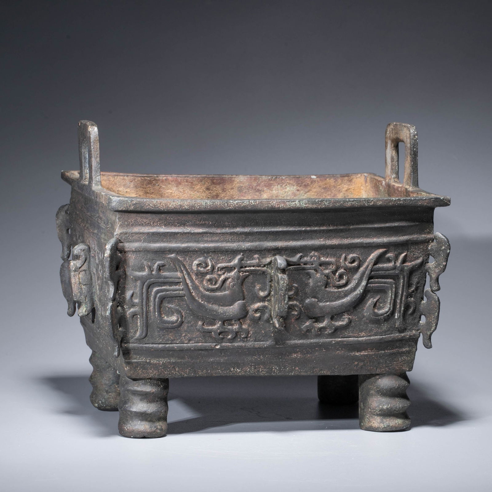 A bronze four-legged ding decorated with phoenix motifs, Ming dynasty: A bronze four-legged ding decorated with phoenix motifs, Ming dynasty