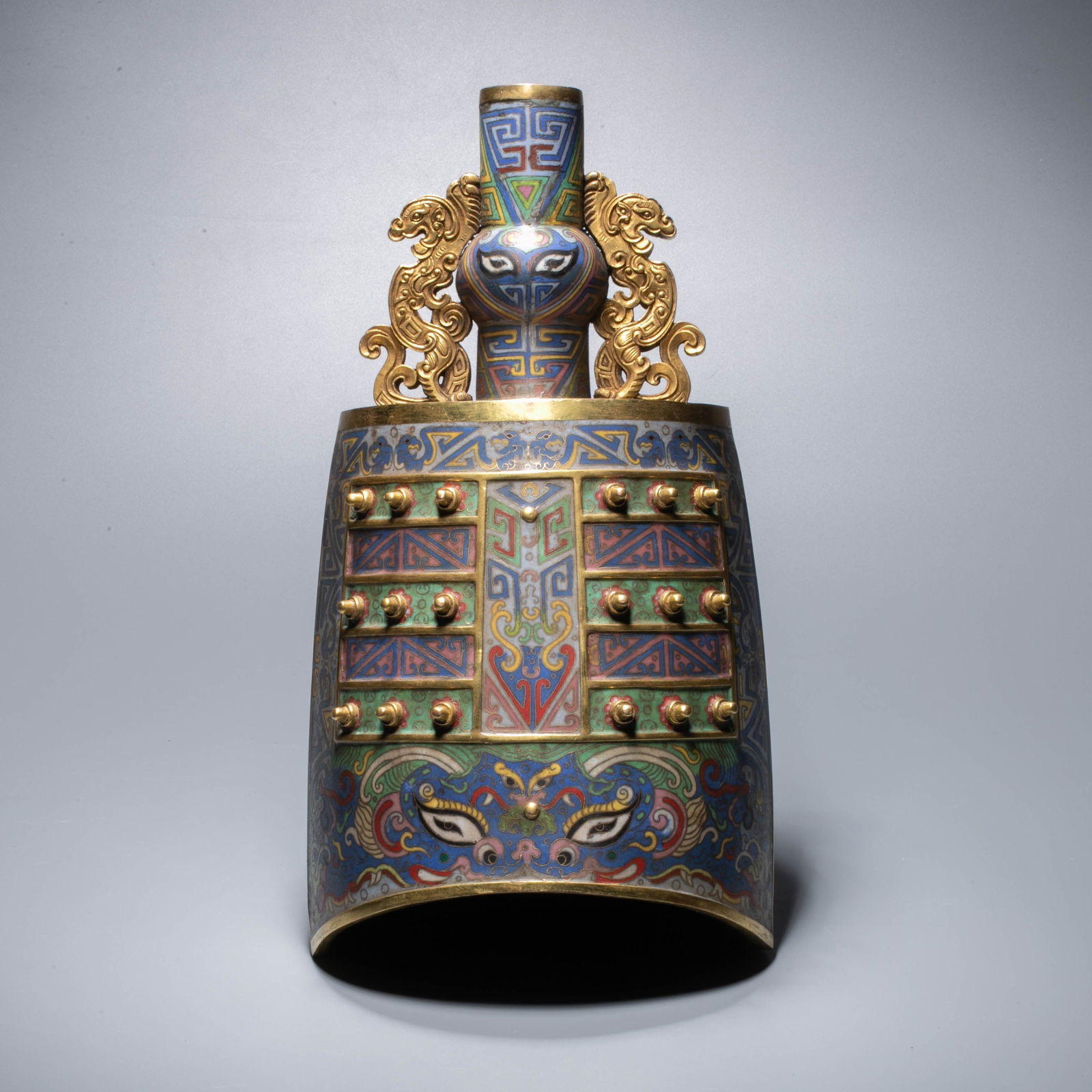 Imperial Cloisonné Enamel Bo Bell with Taotie Mask Motifs and Phoenix-Form Handles, Qianlong: This clock is a ritual vessel made by the qianlong court. it is made of copper body and covered with filigree enamel. the shape of the bell imitates that of ancient bronze bells, with a tile-shaped sh