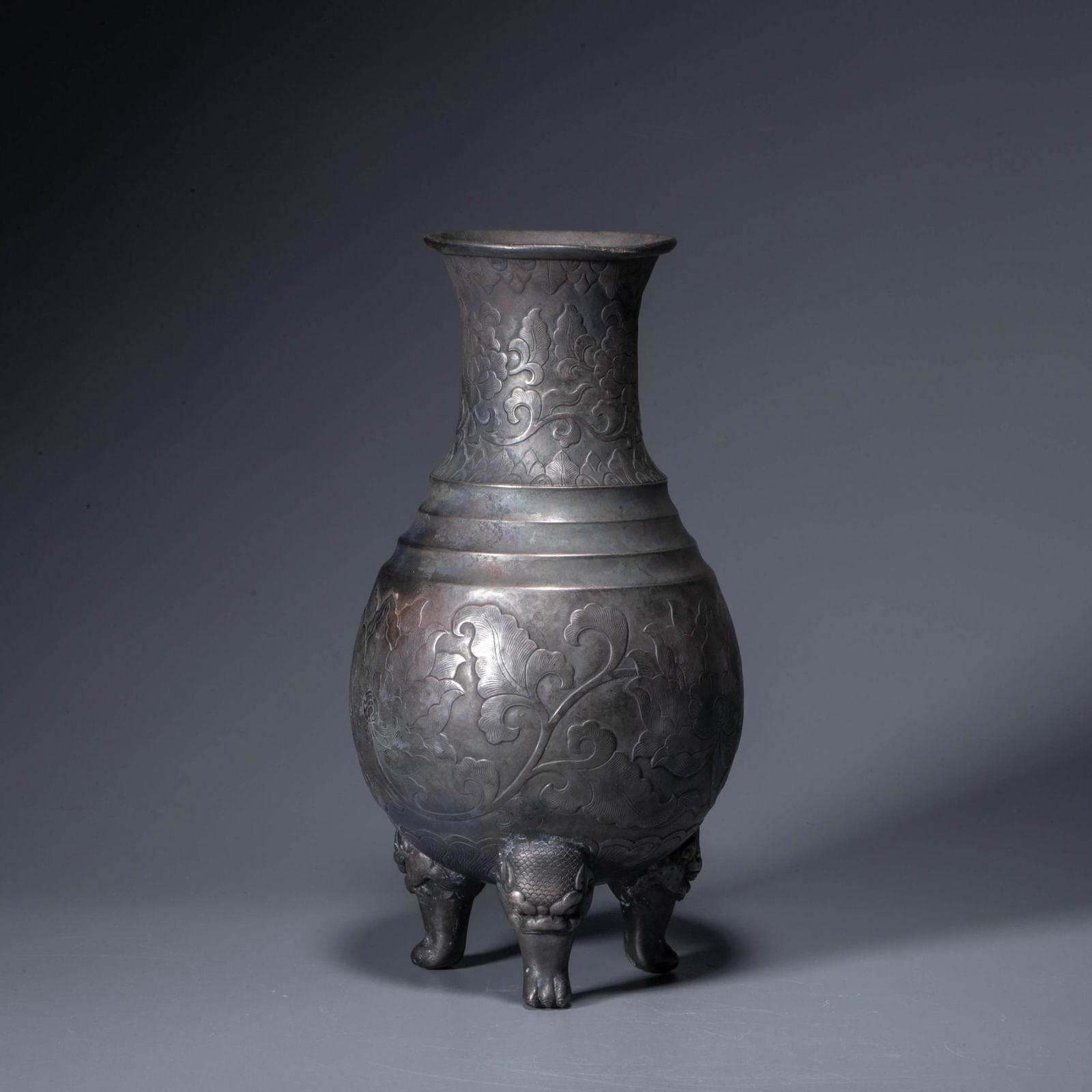 A silver tripod ewer decorated with floral motifs, Ming dynasty: A silver tripod ewer decorated with floral motifs, Ming dynasty